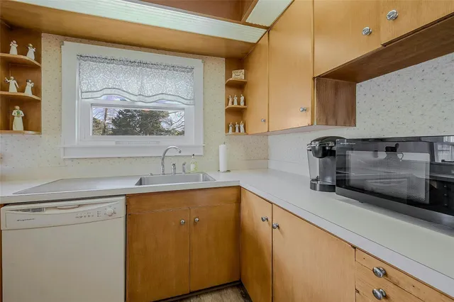 a kitchen with a sink and cabinets