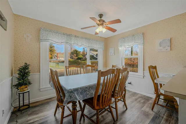 a view of a dining room with furniture window and wooden floor