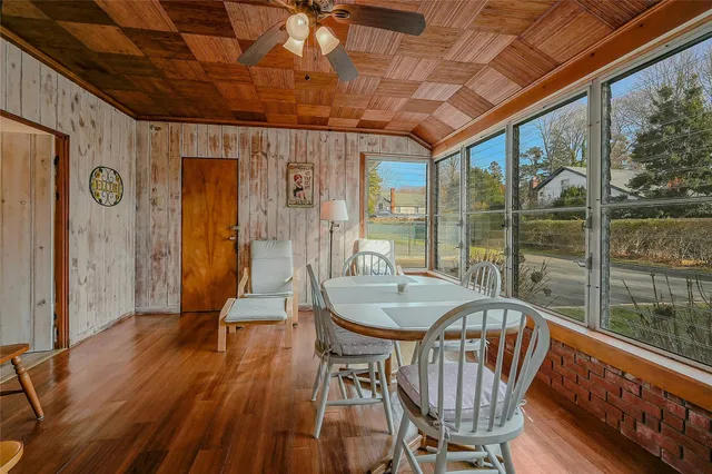 a dining room with furniture window and wooden floor