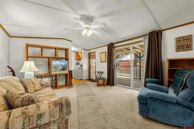 a bedroom with furniture and a large window