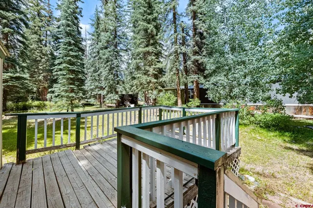 a balcony with wooden floor and fence