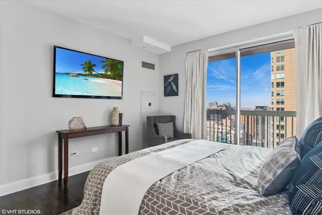 a bedroom with a large bed and a window