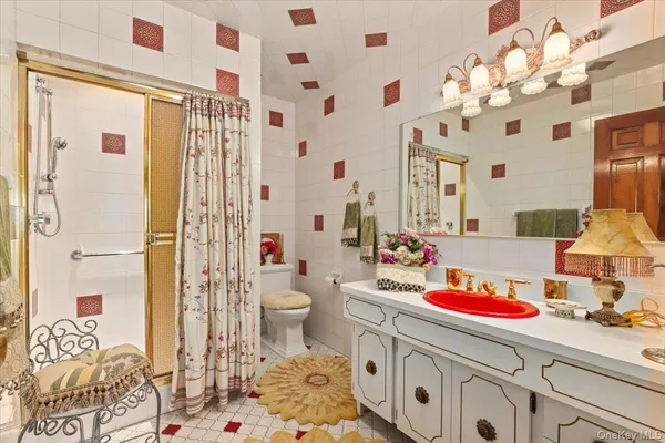a bathroom with a sink a toilet and shower curtain