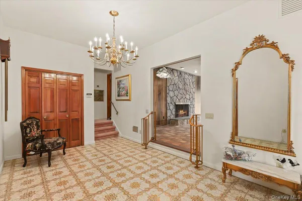 a view of a bedroom with furniture and chandelier