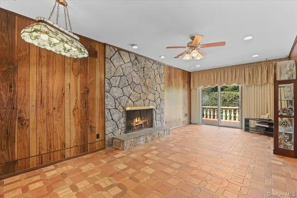 a view of an empty room with a fireplace and a window