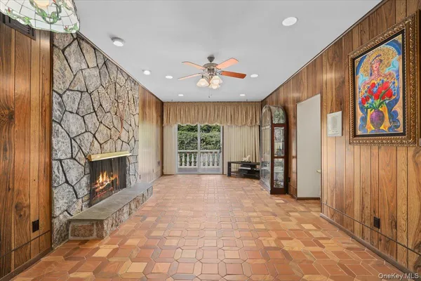 a view of an empty room with a fireplace and a window
