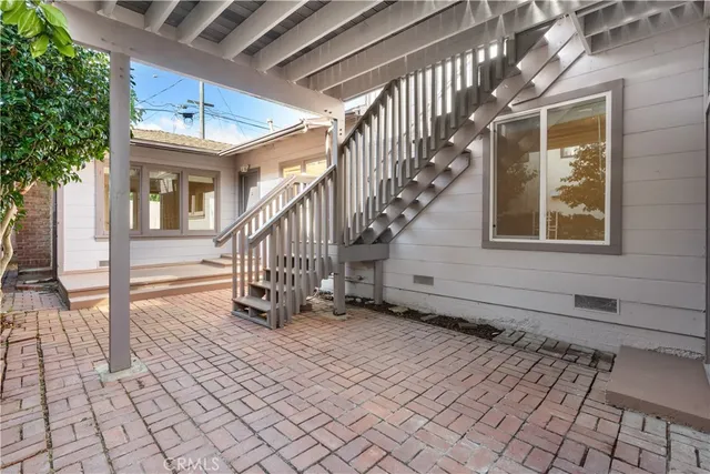 a view of a kitchen with furniture and wooden floor