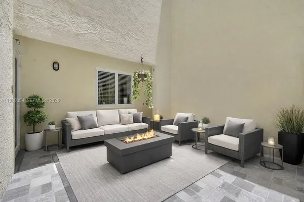 a living room with furniture and a potted plant