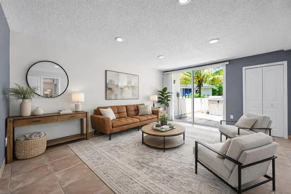 a living room with furniture and a potted plant