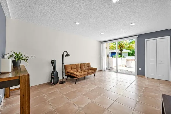 a view of a livingroom with furniture and an empty room