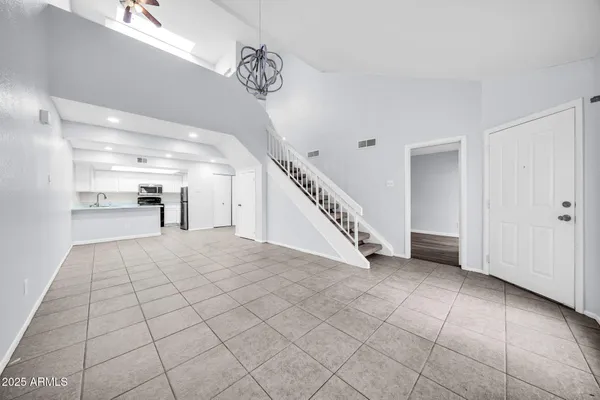 a view of a livingroom with furniture and stairs