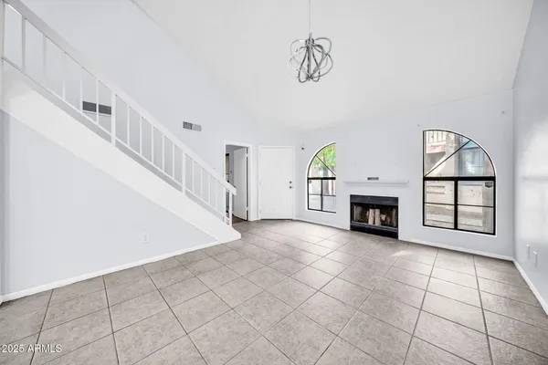 a view of an empty room with a fireplace and a window