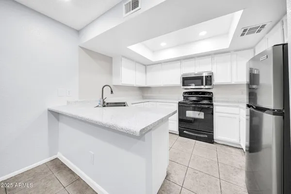 a kitchen with a sink appliances and cabinets