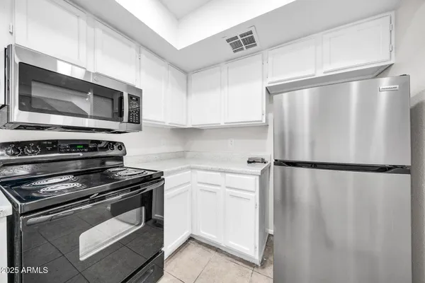 a kitchen with a refrigerator stove and microwave