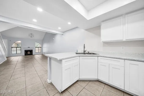 a kitchen with cabinets and window