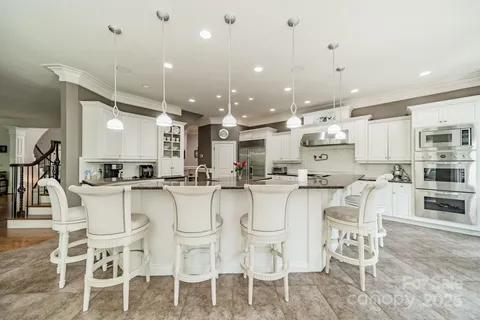a living room with furniture fireplace and a large window