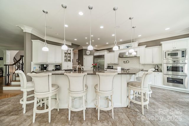 a living room with furniture fireplace and a large window