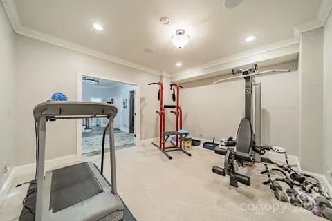 a living room with furniture flat screen tv and windows