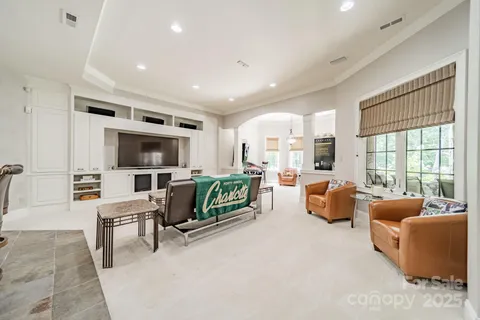 a view of a house with swimming pool and sitting area