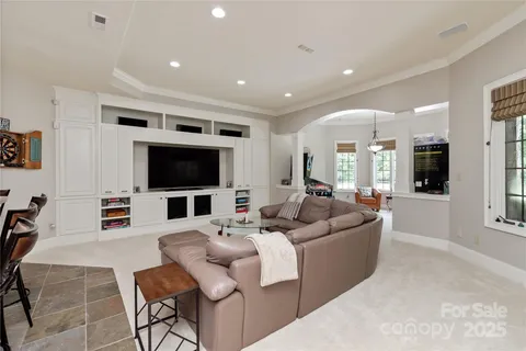 a view of a swimming pool with lawn chairs under an umbrella