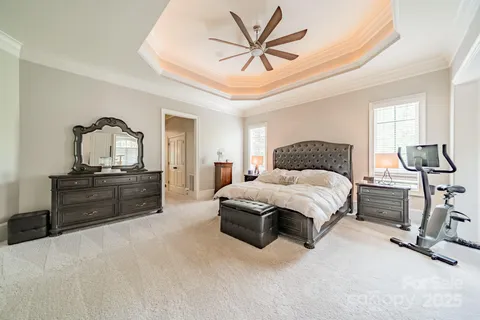 a spacious bedroom with a bed and a fireplace
