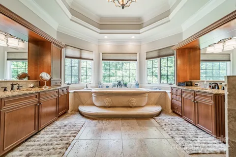 a kitchen with granite countertop white cabinets and appliances