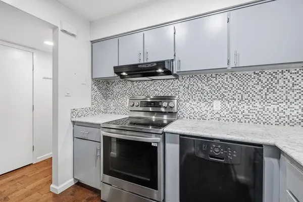 a kitchen with a refrigerator and a sink