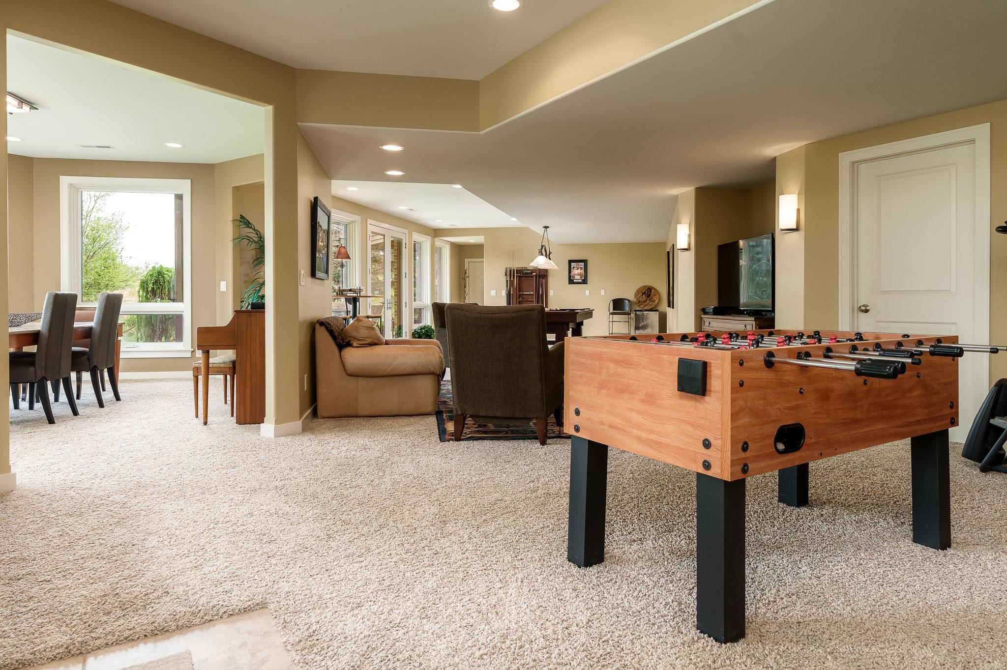 978 Timber Ridge Trail Rockford, IL 61114 - Photo 54 of 86 a living room with furniture a table and kitchen view
