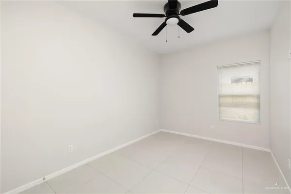 a view of a room with a window and a ceiling fan