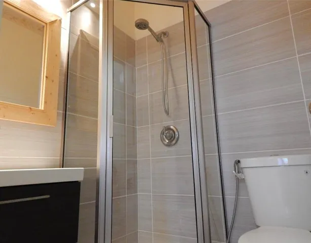 a bathroom with a shower and a sink