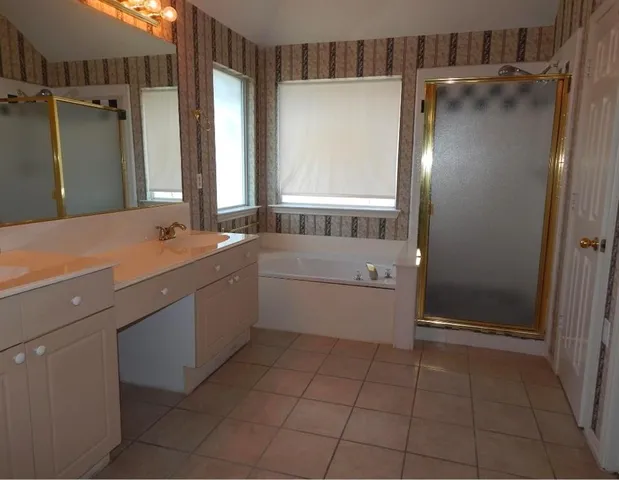 a bathroom with a sink a toilet and a shower