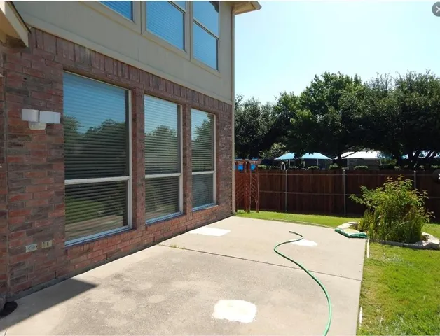 a yellow house in middle of the forest