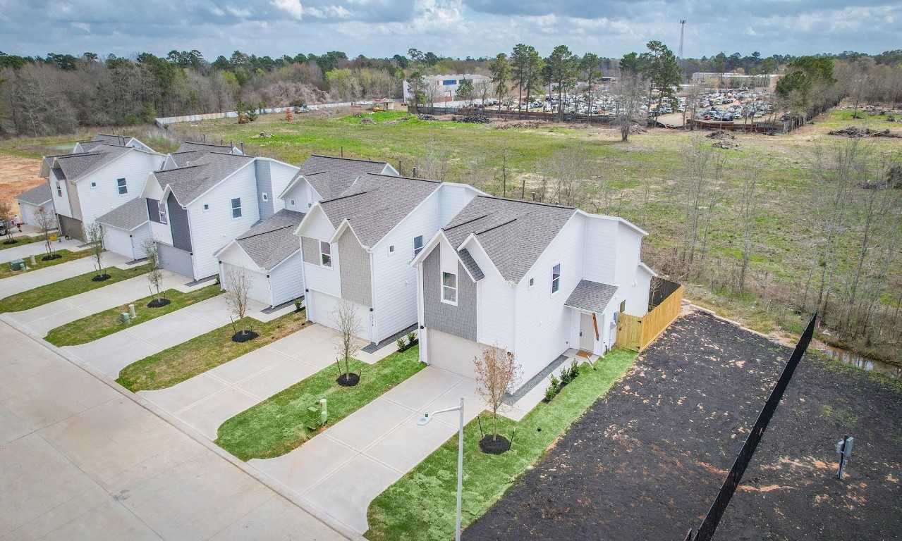 an aerial view of a house with a garden and lake view