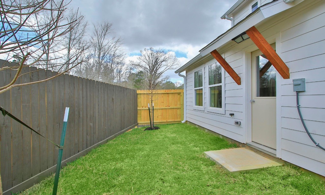 2709 Discovery Trails Conroe, TX 77301 - Photo 22 of 24 a view of backyard with a cabin and wooden fence