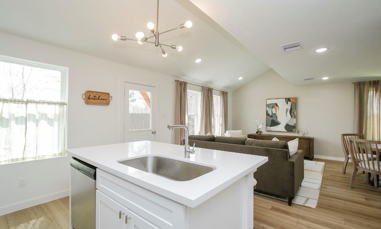 2709 Discovery Trails Conroe, TX 77301 - Photo 4 of 24 a kitchen with granite countertop a sink a counter top space and living room view