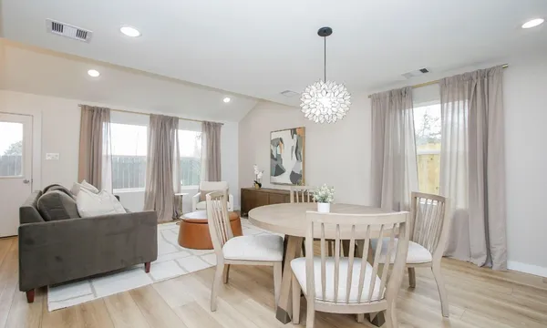 a view of a dining room with furniture window and wooden floor
