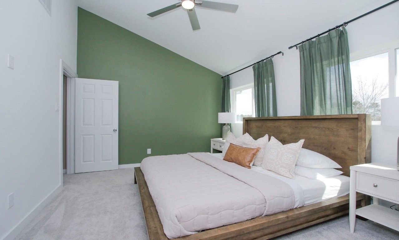 2709 Discovery Trails Conroe, TX 77301 - Photo 10 of 24 a bedroom with a bed and a chandelier