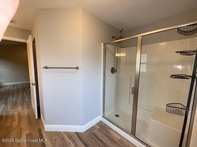 a bathroom with a glass shower door