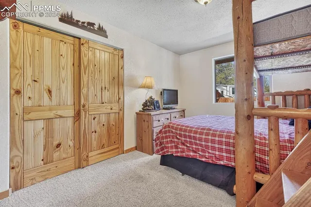 a bedroom with a bed and large window