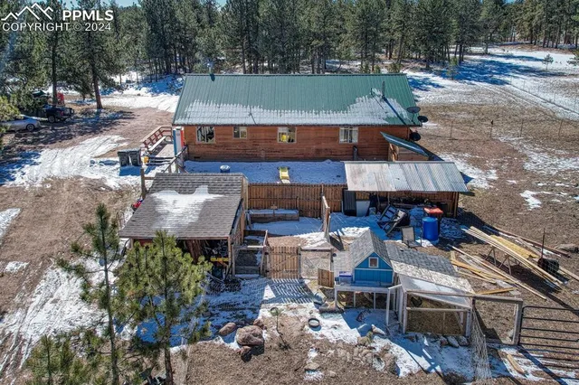 an aerial view of a house with a yard