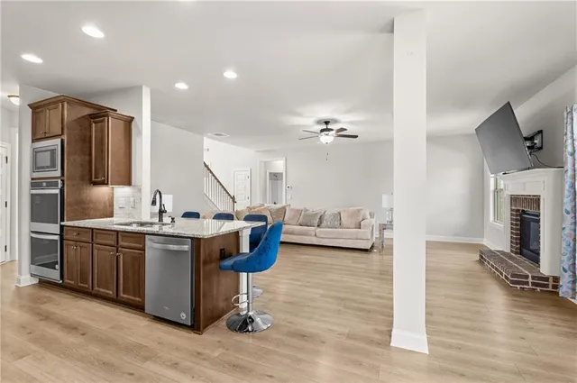 a view of living room with kitchen island furniture and wooden floor