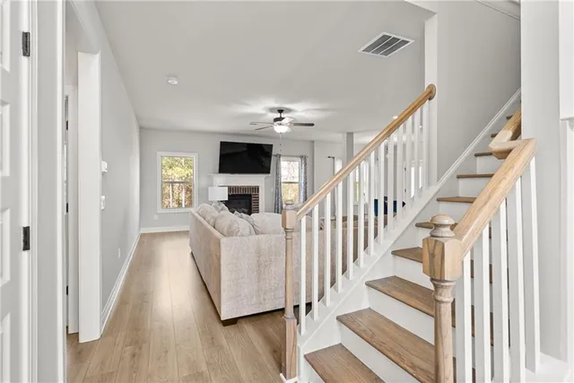 a view of entryway and hall with wooden floor