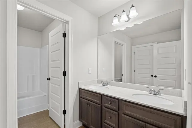 a bedroom with bed couch and window