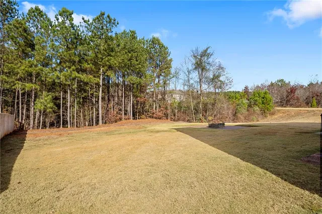 a view of a pool with lawn chairs