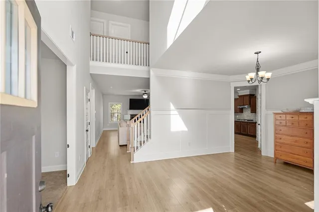 a view of entryway and hall with wooden floor