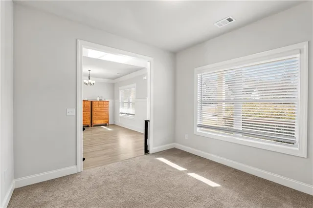 a view of a room with a window and a kitchen