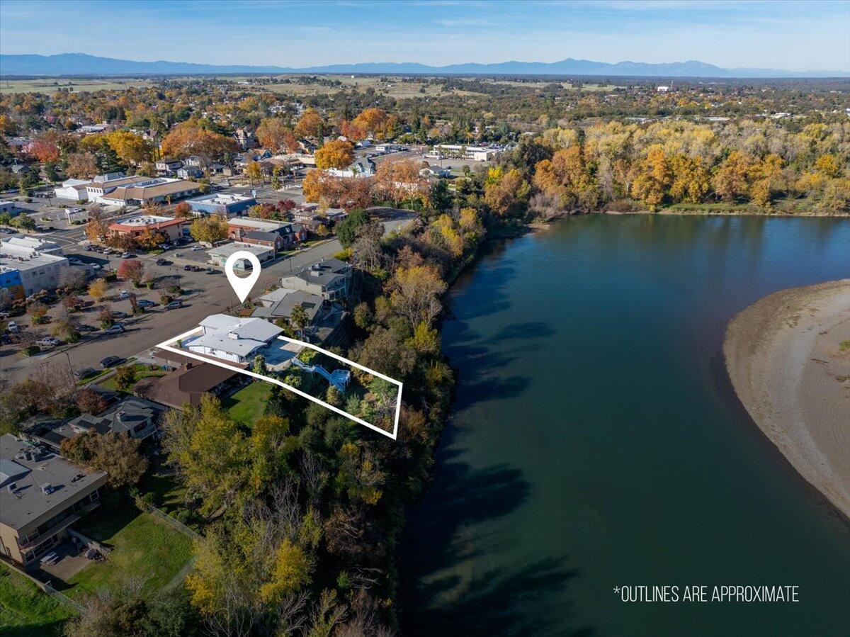 an aerial view of a house with a lake view