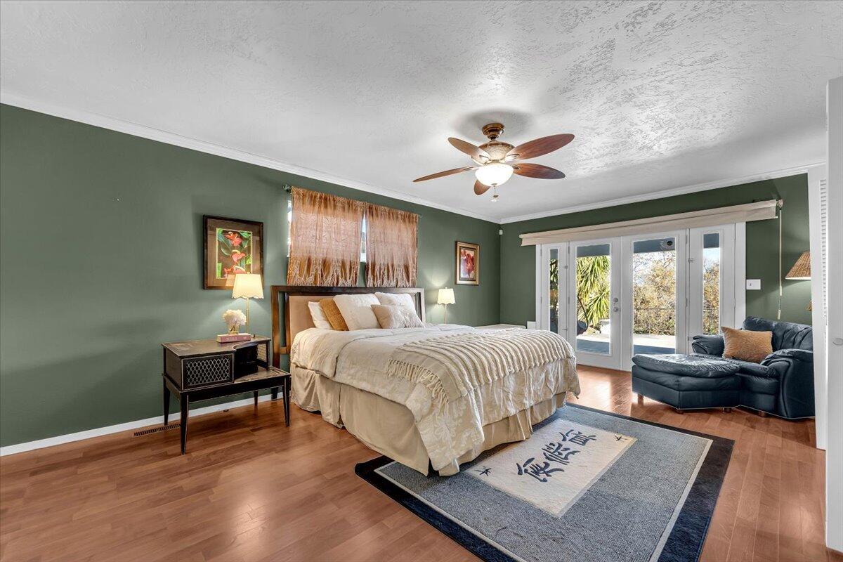 846 Rio Street Red Bluff, CA 96080 - Photo 23 of 73 a bedroom with a bed and a chandelier