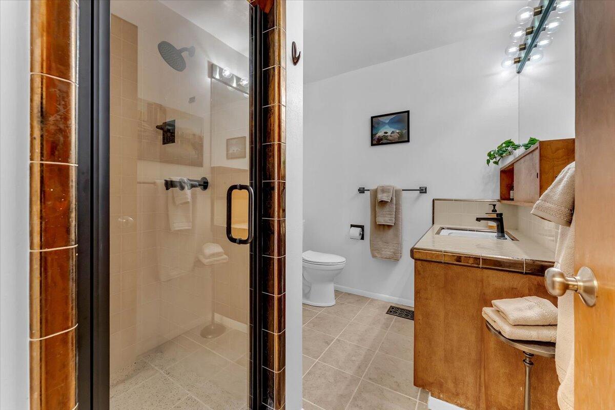 846 Rio Street Red Bluff, CA 96080 - Photo 31 of 73 a bathroom with a granite countertop sink and a washing machine