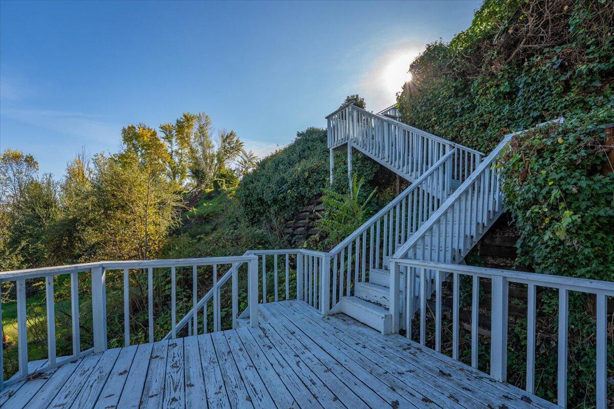 846 Rio Street Red Bluff, CA 96080 - Photo 58 of 73 a balcony with wooden floor and trees in the background
